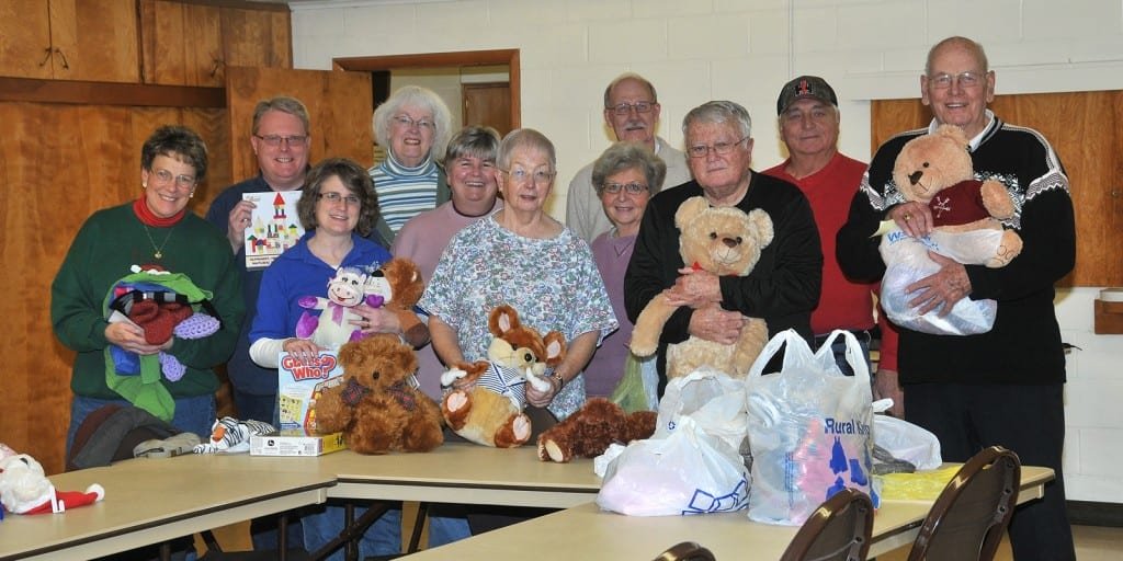 EAMA CHRISTMAS WORKSHOP … Pausing before packaging more gifts for the 2012 Edon Area Ministerial Association’s A Caring Christmas were, from left, Lynn Wilson, Pastor David LaDuke, Sue LaDuke, Gretchen Mauerhan, Sandy Bauer, Joan Marlow, Larry Hasselschwert, Char Word, Pastor Roger Marlow, Wayne Word and Karl Mauerhan. This year, packages were delivered to nearly twenty-five families throughout the area.