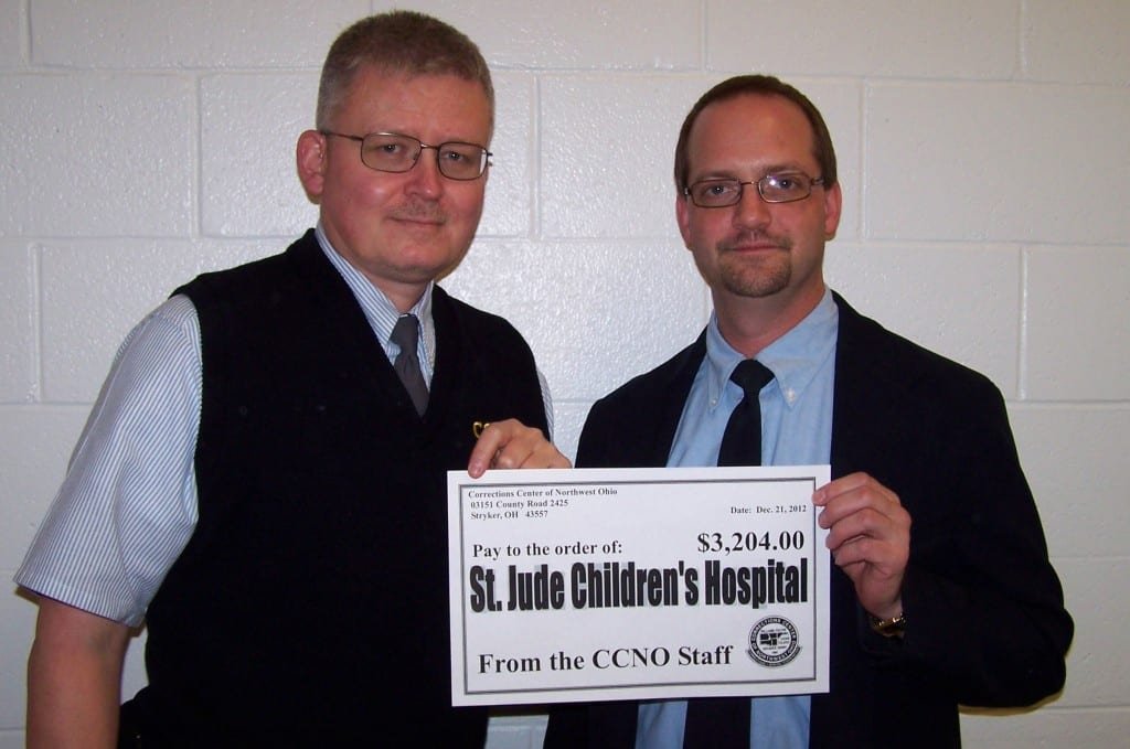 DONATION ... CCNO Corrections Supervisor Pat Miller and Corrections Officer John Zimman holding a check to be presented to St. Jude Children’s Research Hospital. Supervisor Miller donated numerous handmade items for the raffle while Officer Zimman was the lucky recipient of several donated items.