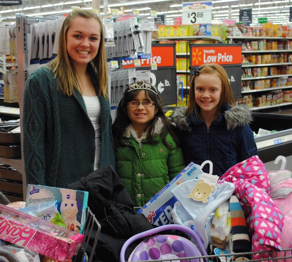 GIVING BACK ... The Miss West Unity Queens spent the holidays giving back to a local family in need. From clothing to toys to food, the girls shopped, wrapped and delivered a wonderful holiday surprise. Shown with a cart full of goodies are Miss West Unity Emily Maneval, Little Miss West Unity Brianna Bell and Junior Miss West Unity Jayla Stannard.