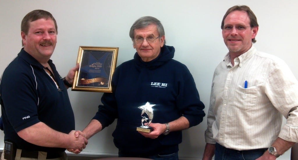 AWARD ... Pictured presenting the award (left to right) Alan Bennett, Chamber President Dr. Bob Smith, Board Member and Superintendent, Dan Woodring, Chamber Director