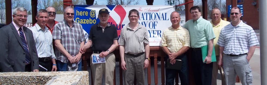 DAY OF PRAYER ... Pastors and other village representatives prayed at the gazebo in Pioneer during their service for the National Day of Prayer. Left to right: Mayor Ed Kidston, Pastor Mark Pittman, Pastor Mike Wilder, Cliff Iles, Pastor Mike Raypholtz, Robert Delves, Pastor Gene McBride, Pastor Steve Smith, and Shane Martin of the North Central Schools Board of Education.