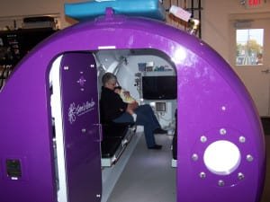 PHOTO BY TAMMY ALLISON, STAFF COMFORT ZONE ... Judy Burkholder, Clinic Director, and granddaughter sit inside their hyperbaric oxygen chamber.