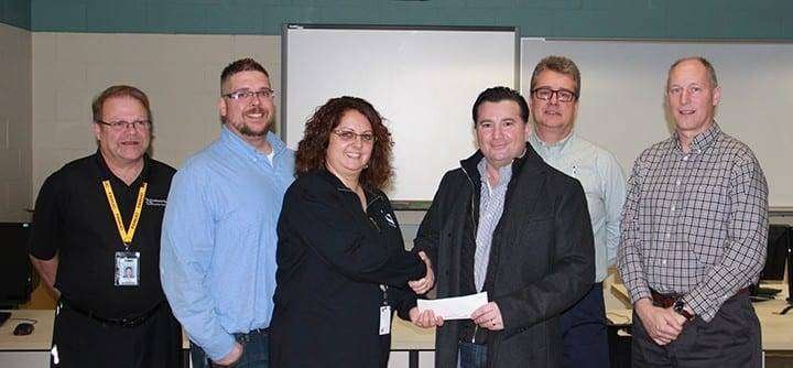 Alberto Spallino, representing the Gene Haas Foundation, presents a grant check for $15,000 to Melissa J. Rupp of Northwest State Community College. The grant will provide scholarships benefitting students who enroll in machining-based training programs at the College. Pictured: From L to R: Tom Bowes and Colin Doolittle (NSCC faculty), Rupp (NSCC Director of Grant Development & Administration), Spallino (Sales Engineer, Haas Factory Outlet), Jim Drewes (NSCC Director of Sales/Workforce Development) and Dan Burklo (NSCC Dean of Math, Science & Engineering Technologies).
